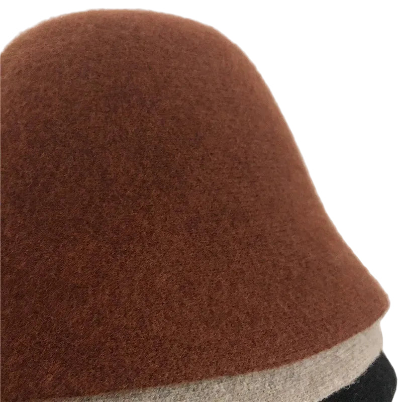 A women's hat made of wool felt, with a hemispherical crown, a cylindrical body, and a short brim. It was the signature women's hat of the 1920s.