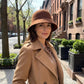 A women's hat made of wool felt, with a hemispherical crown, a cylindrical body, and a short brim. It was the signature women's hat of the 1920s.
