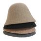A women's hat made of wool felt, with a hemispherical crown, a cylindrical body, and a short brim. It was the signature women's hat of the 1920s.